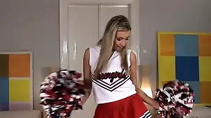 Cherry Jul, a young blonde cheerleader, in a solo act wearing her uniform