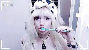 Blonde teen's playful toothbrushing and foamy shower fun